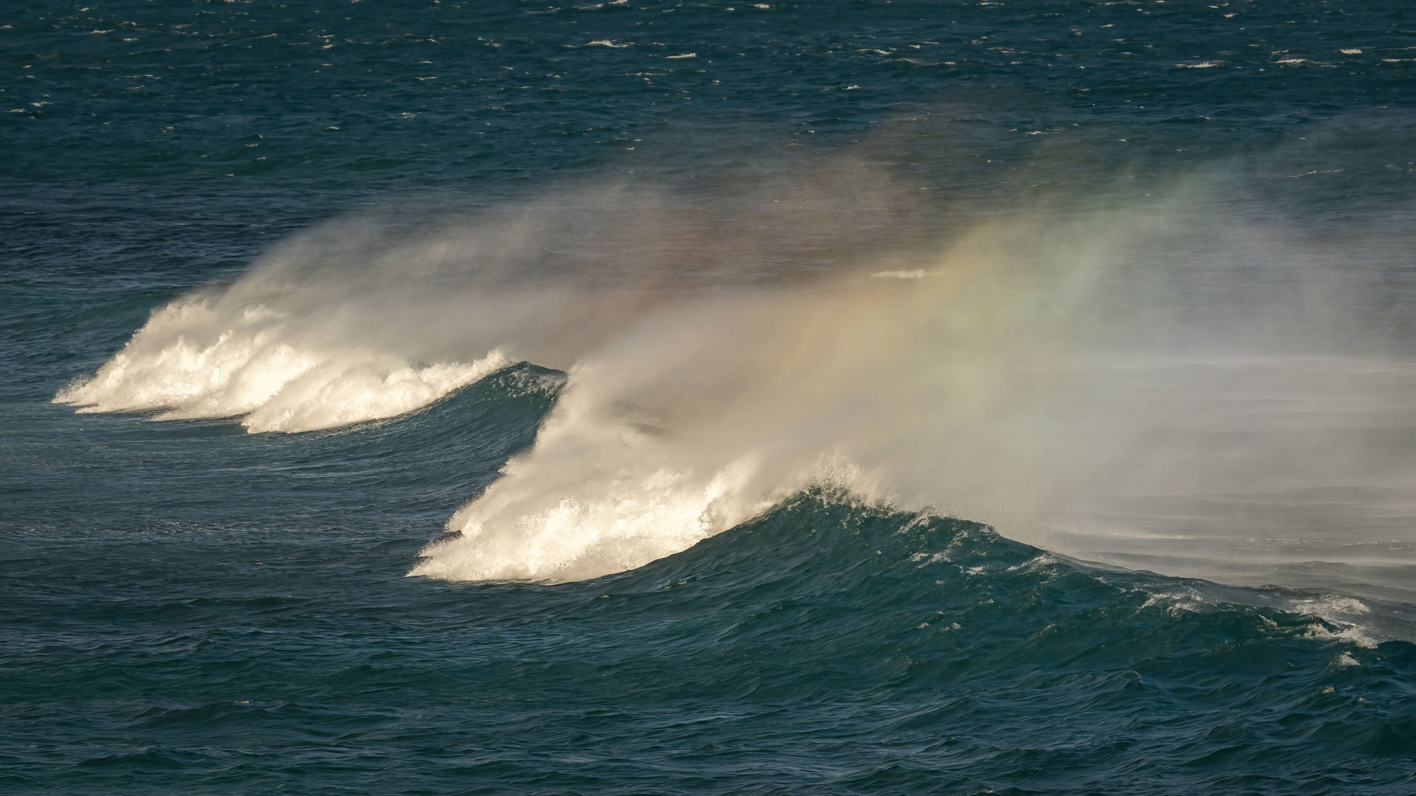 Maui's mermaid mist, with a rainbow forming in the ocean spray